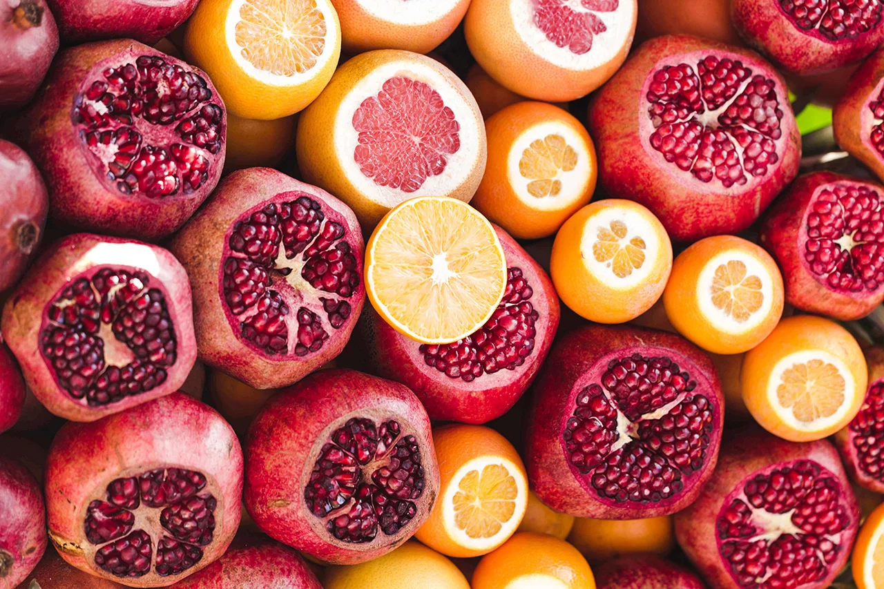 Vibrantly colored mix of sliced navel oranges, blood oranges and pomegranate fruit